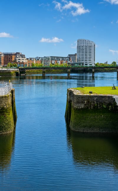 Limerick's River Shannon docks with modern apartment blocks, a graving dock and an old red-brick pump house