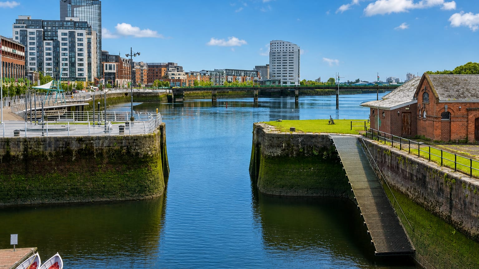 Limerick's River Shannon docks with modern apartment blocks, a graving dock and an old red-brick pump house