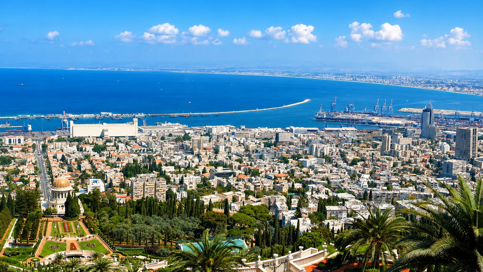 Haifa's Baha'i Gardens and golden-domed Shrine of the Bab descending toward the port and Mediterranean bay under a clear sky.