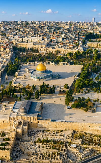 Aerial view of Jerusalem's Old City with the golden Dome of the Rock and Temple Mount amid dense stone buildings