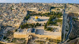 Aerial view of Jerusalem's Old City with the golden Dome of the Rock and Temple Mount amid dense stone buildings