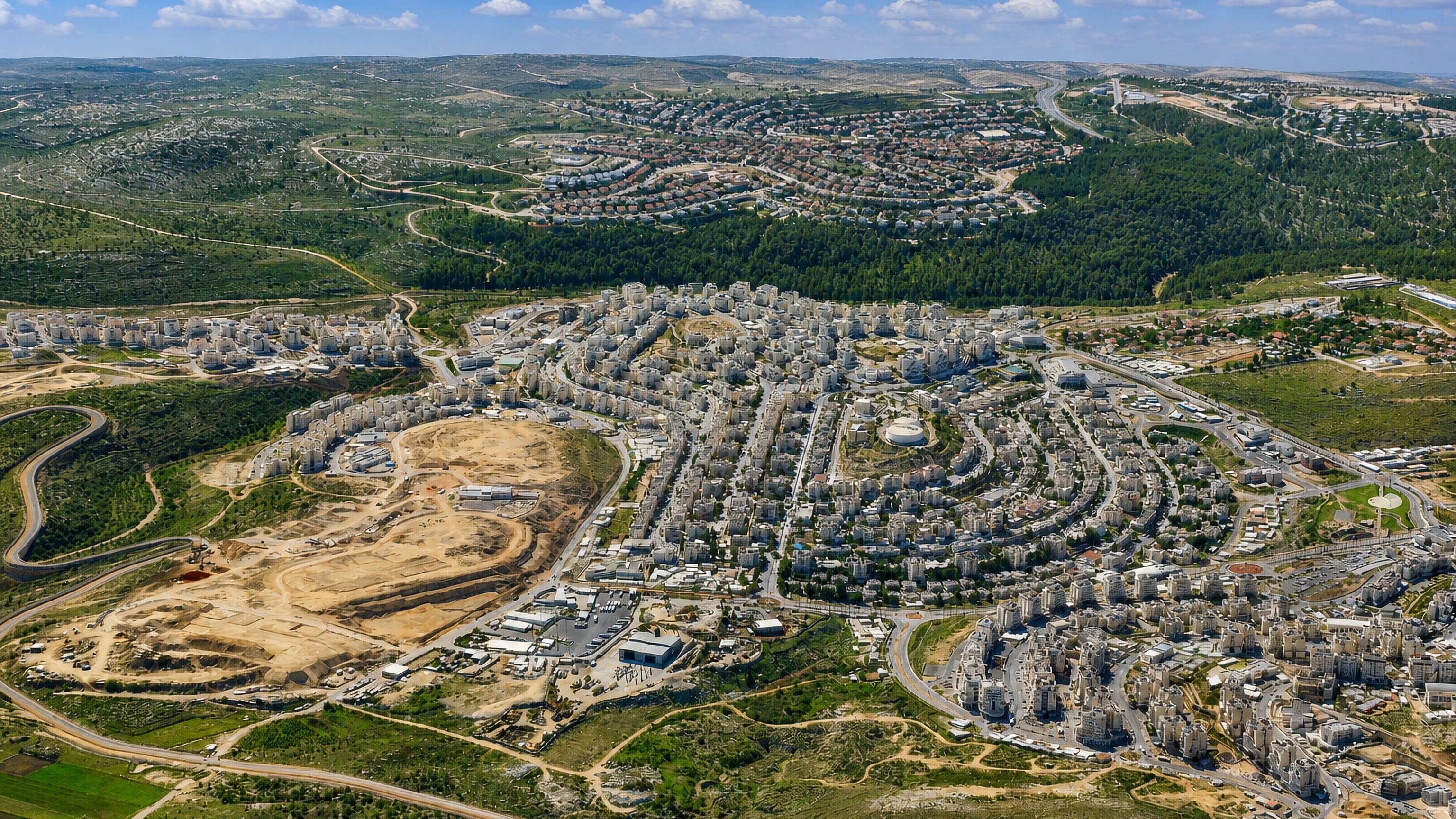 Aerial view of Modiin Ilit, Israel, white apartment blocks spread across the Judean hills