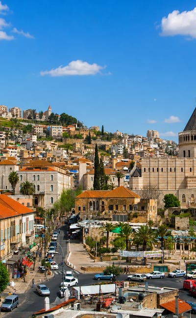 Nazareth townscape with the domed Basilica of the Annunciation rising above red-roofed houses under a blue sky