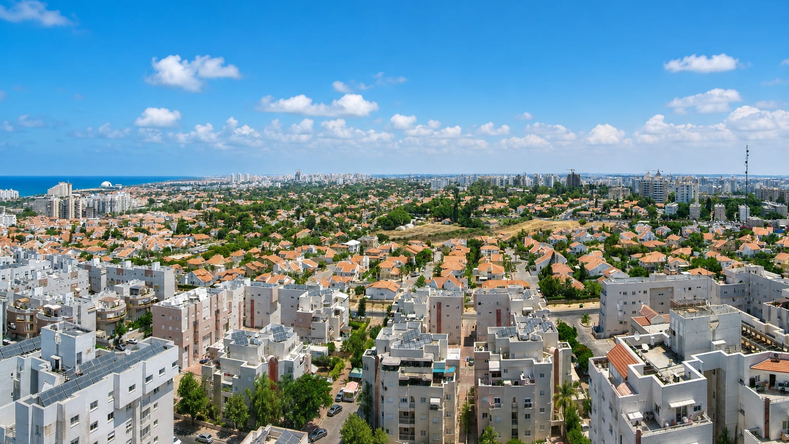 Aerial view of Ashkelon's residential districts and villas reaching toward the Mediterranean coast.