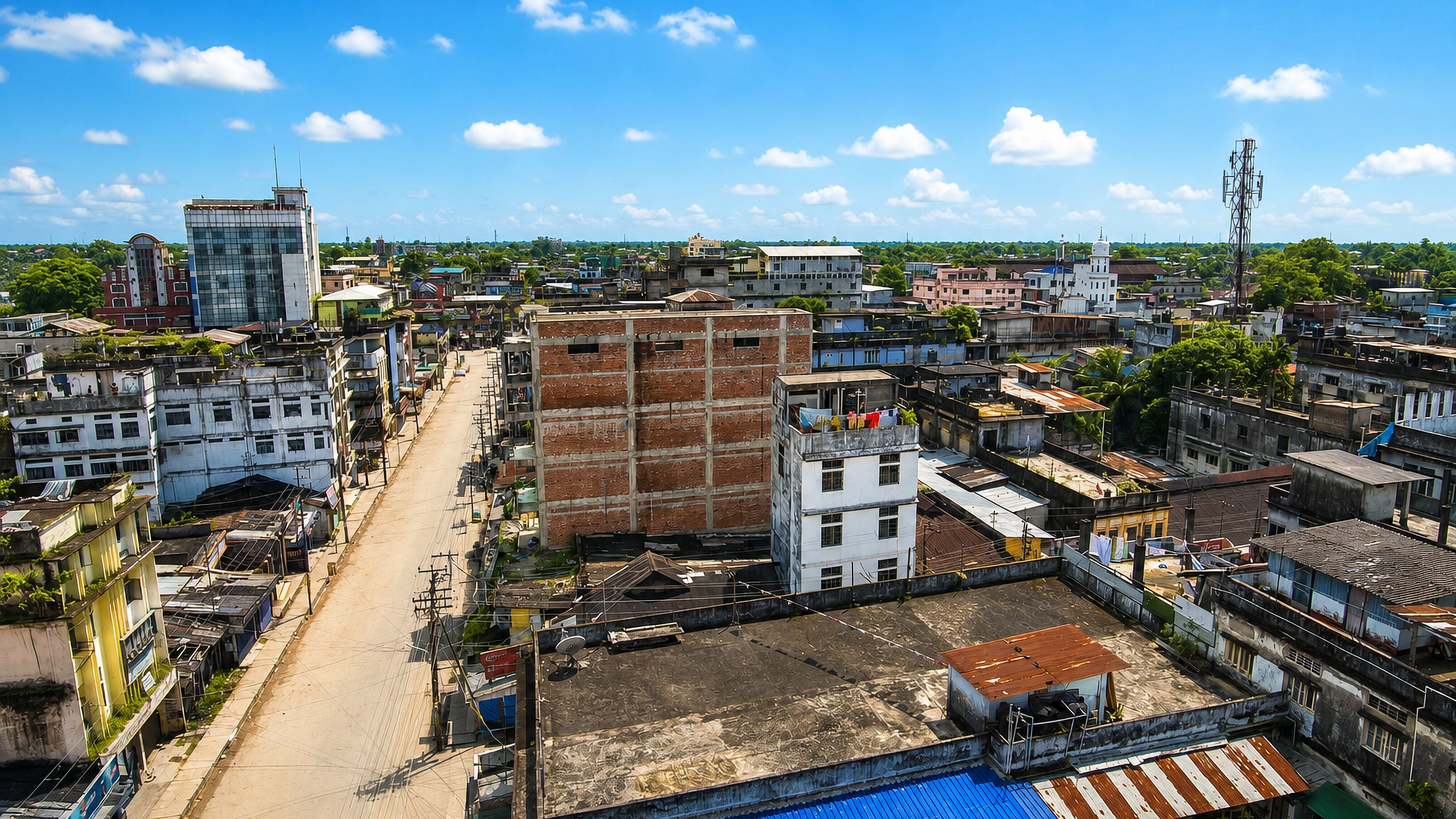 Rooftops, a market street and a telecom mast across central Dibrugarh, Assam.