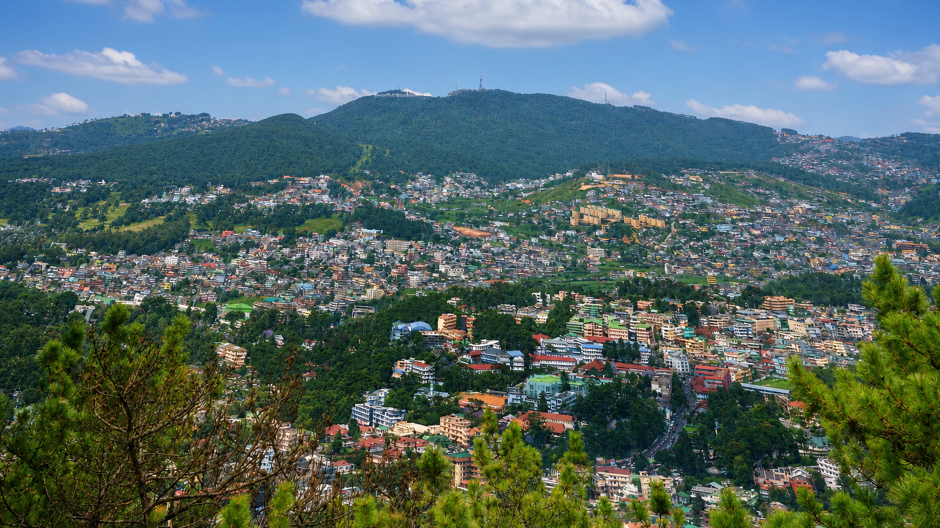 Hillside townscape of Shillong, India, with dense houses climbing forested Meghalaya hills