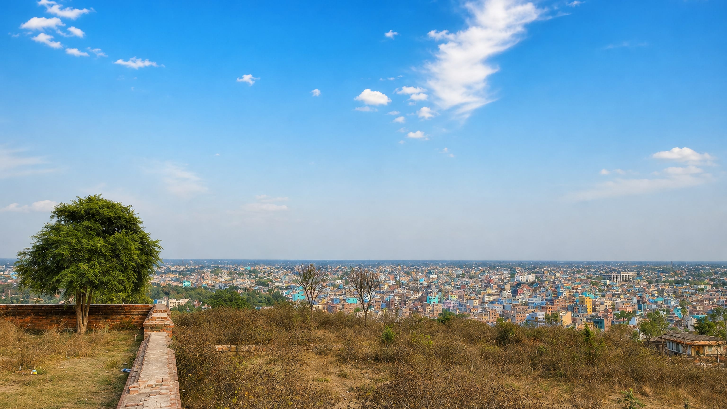 View from an old brick rampart over the dense, colourful rooftops of Bihar Sharif, Bihar.