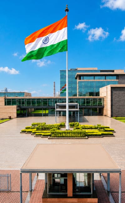 Landscaped plaza and glass office block flying the Indian flag in Raigarh, Chhattisgarh