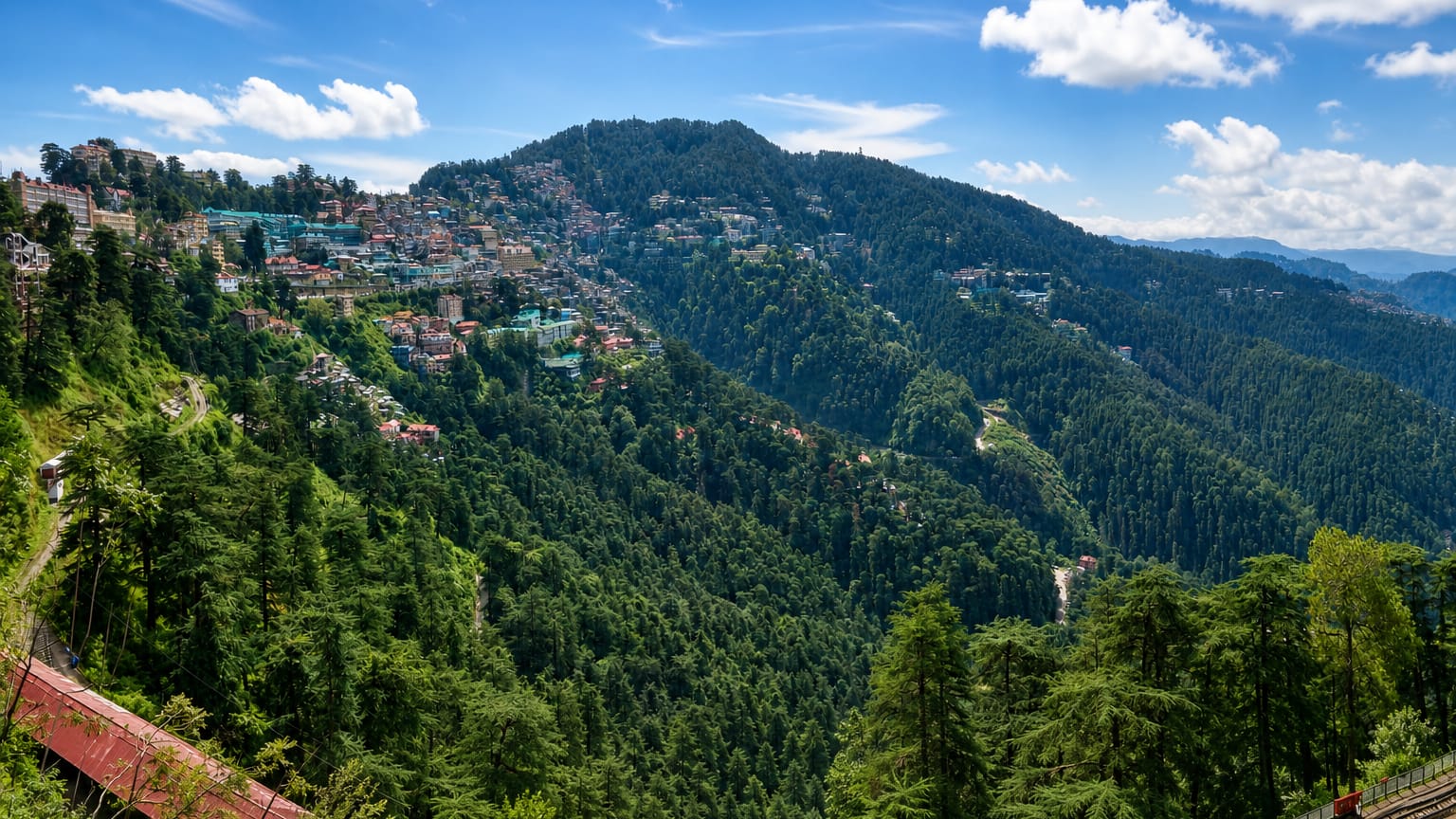 Shimla's hillside houses on forested Himalayan slopes above the railway line