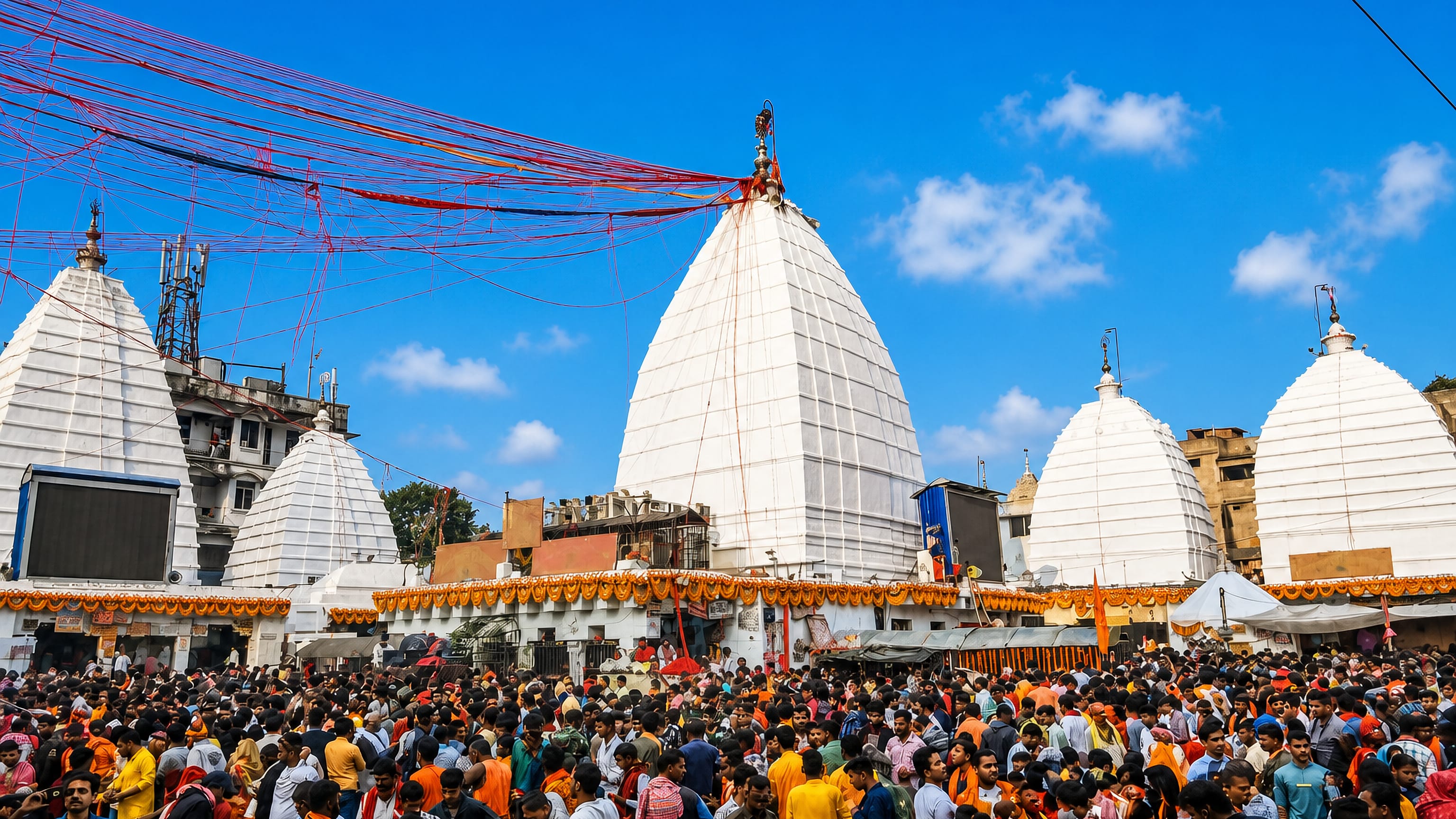 Pilgrim crowds before the white spires of the Baidyanath temple complex in Deoghar, Jharkhand.
