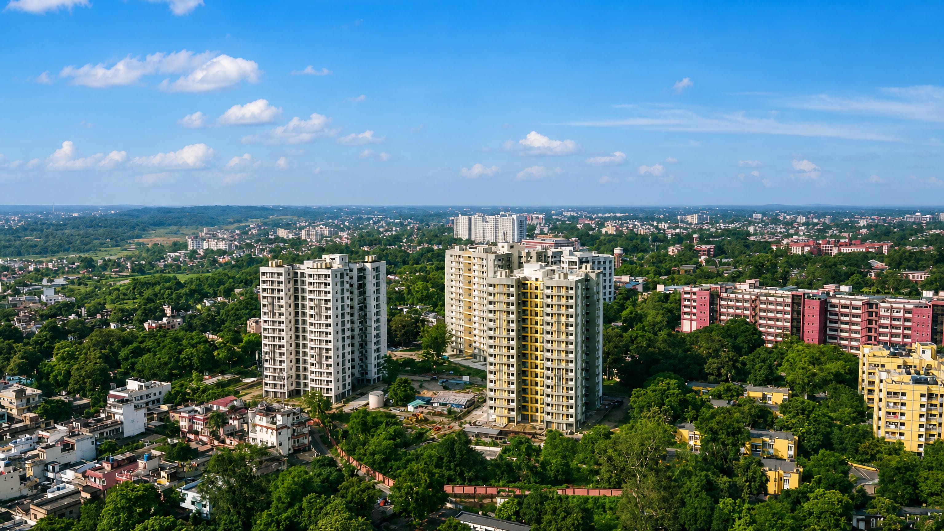 Aerial view over Dhanbad's residential towers and tree-lined neighbourhoods in Jharkhand, India.