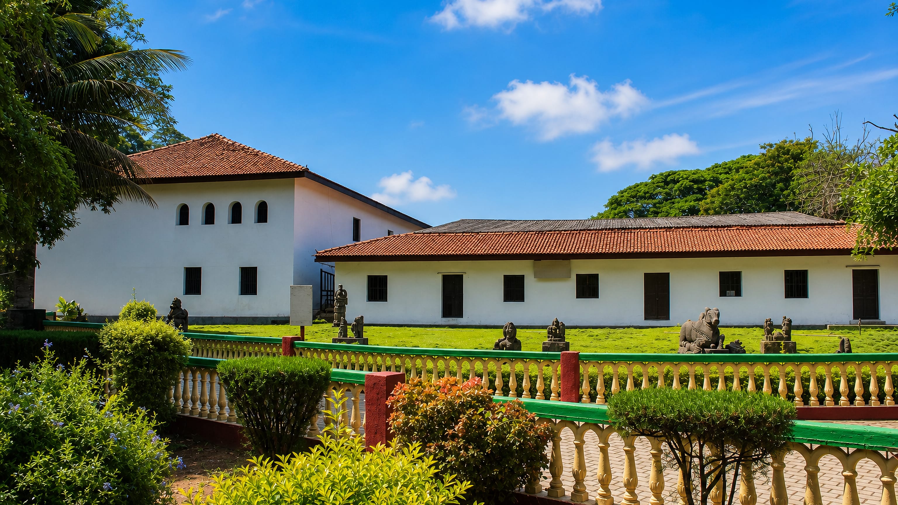 Whitewashed tile-roofed palace museum and stone sculpture garden in Shivamogga, Karnataka