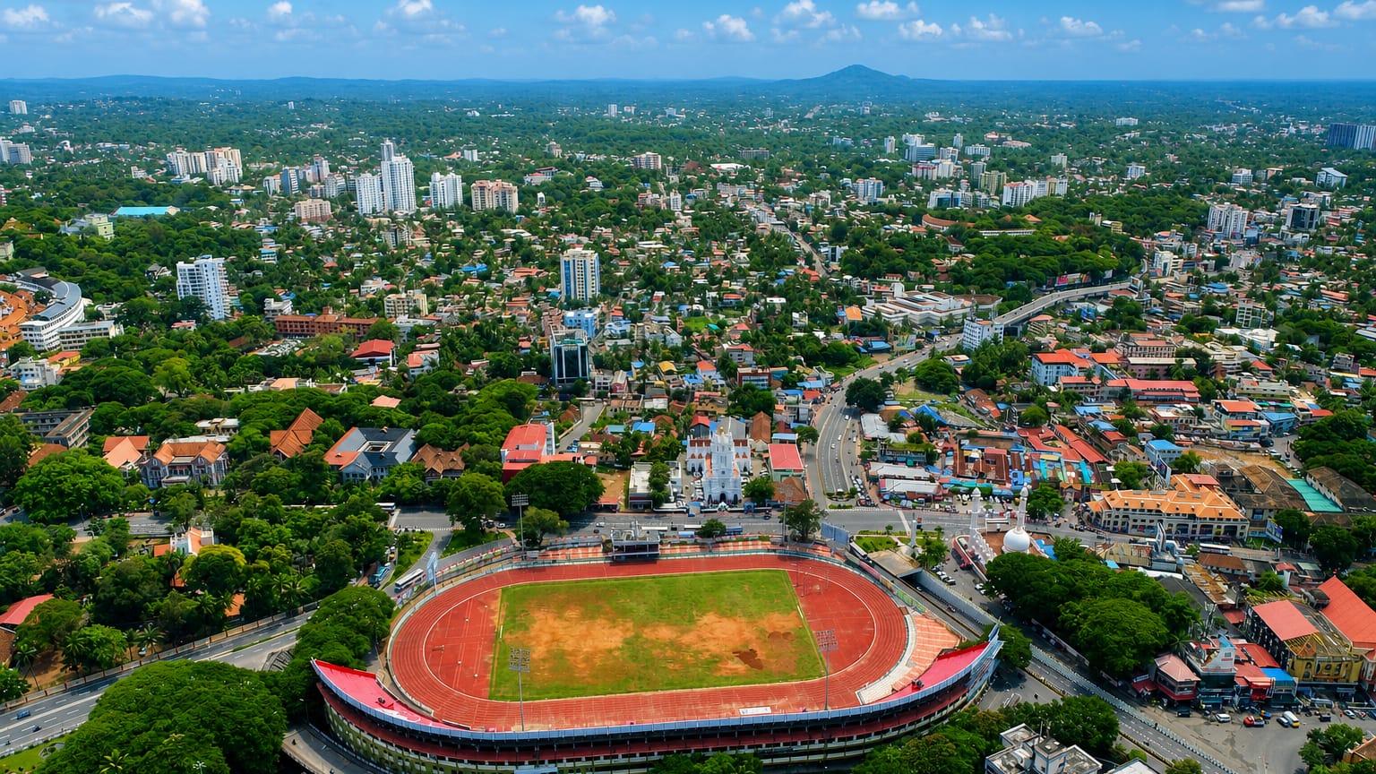 Aerial view of Thiruvananthapuram, India, over the oval Central Stadium and the lush low-rise city