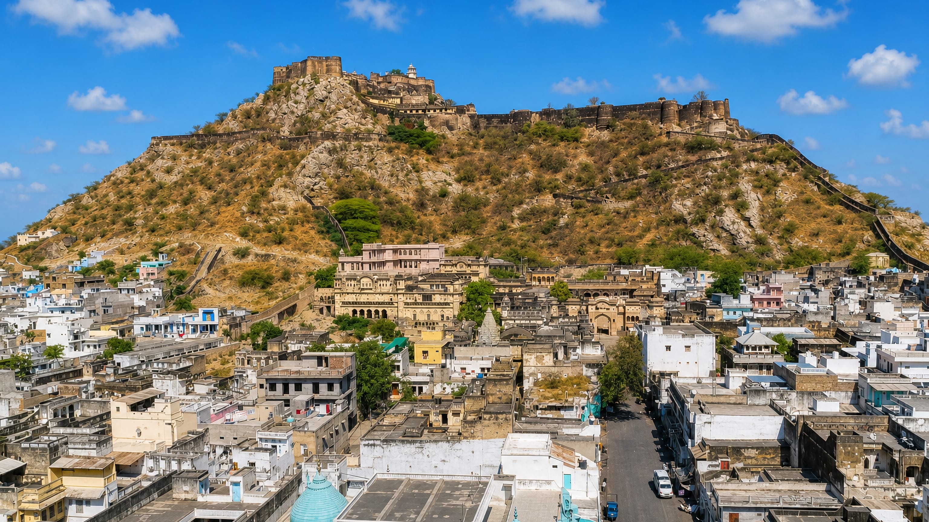 Kuchaman Fort crowning its rocky hilltop above the dense havelis and rooftops of Kuchaman, Rajasthan.