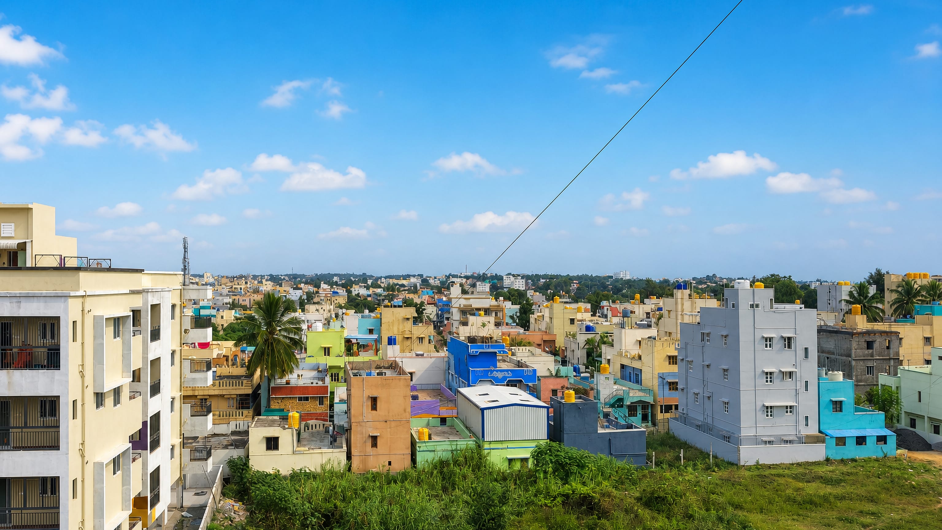 Colourful low-rise houses with rooftop water tanks spread across Hosur, Tamil Nadu.