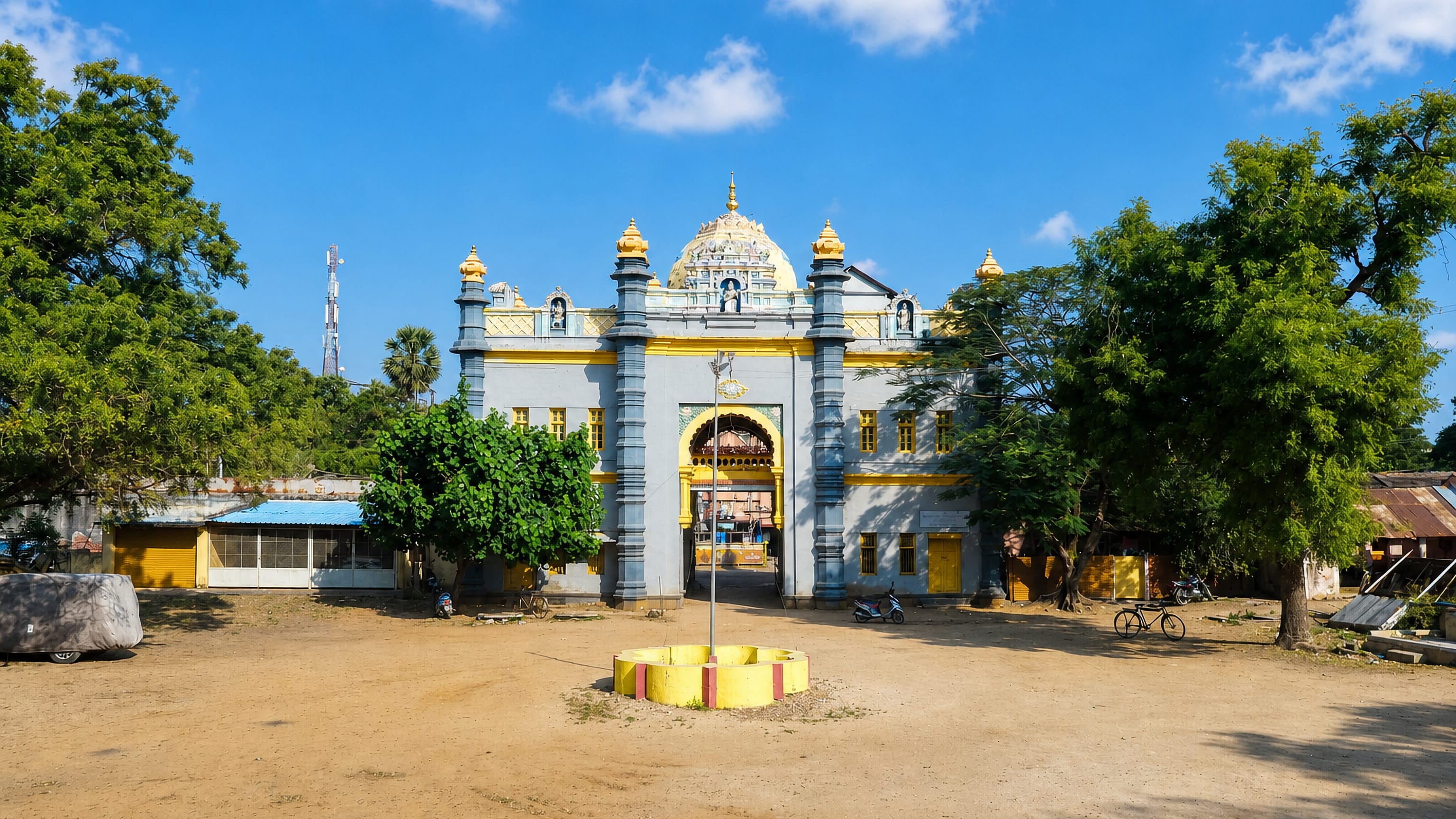 Yellow and grey temple gateway across a dusty open square in Ramanathapuram, Tamil Nadu, India.