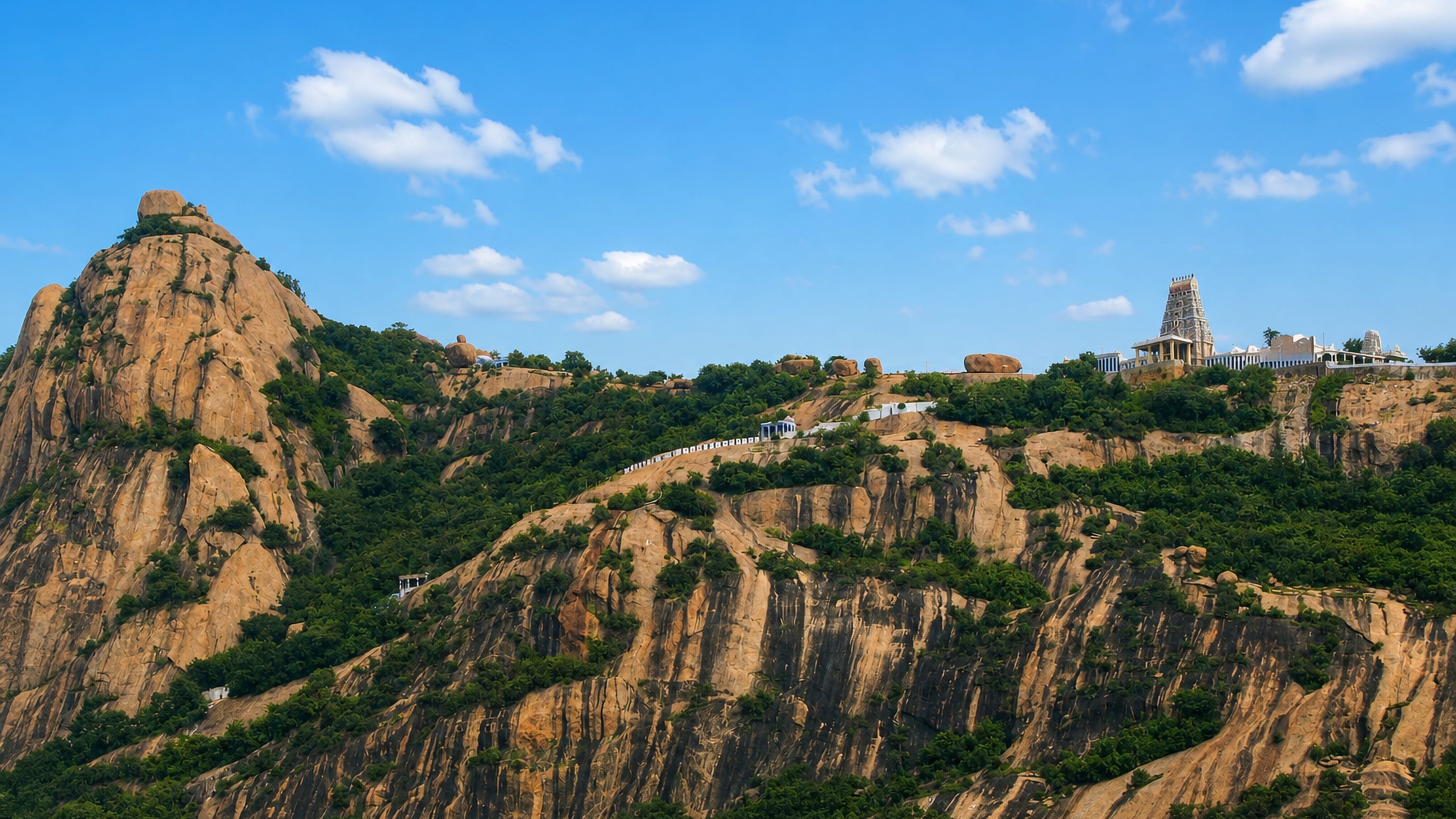 A hilltop temple tower crowning the rocky Nagachalam hill above Tiruchengode, Tamil Nadu.