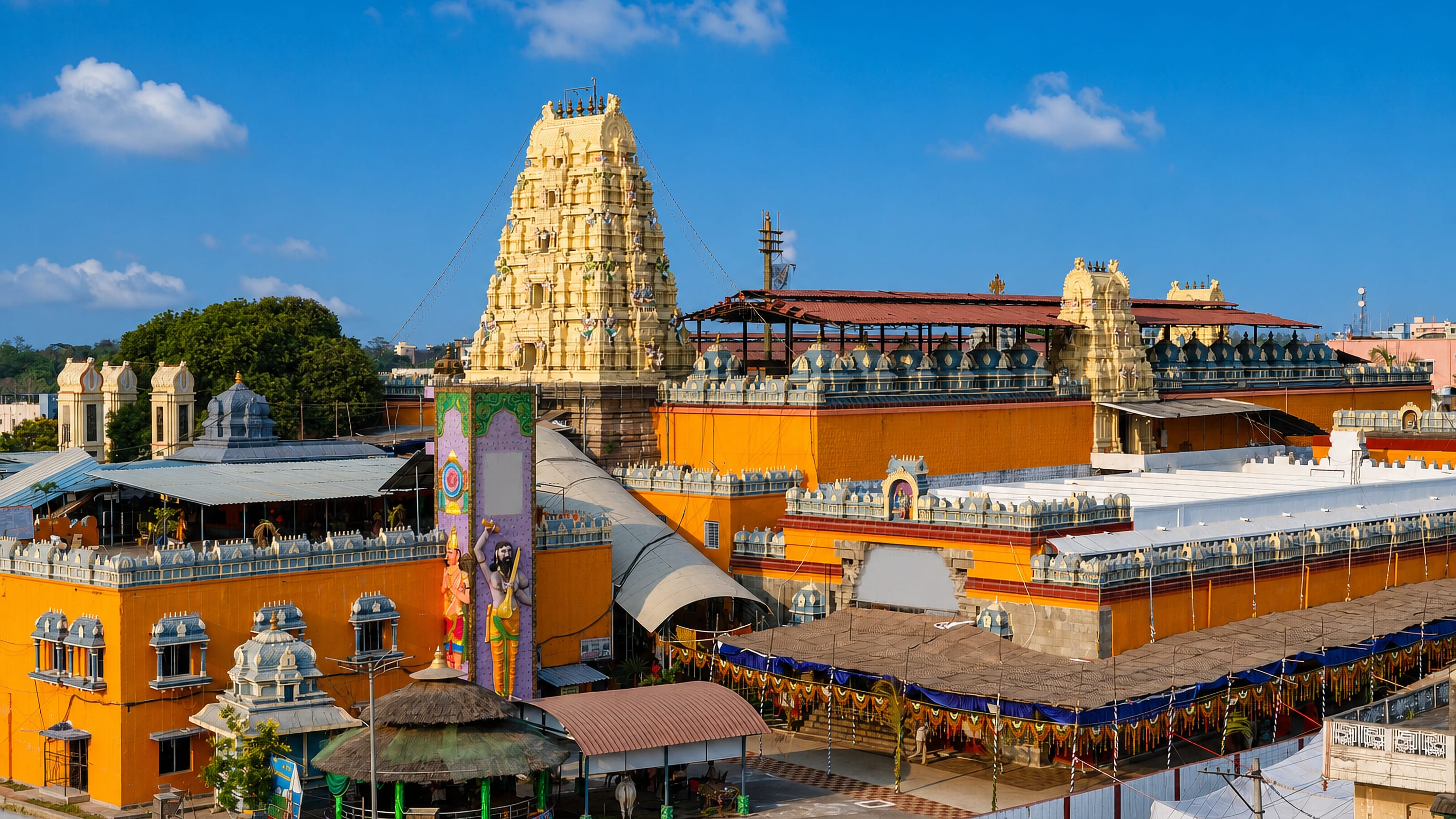 The gopuram and orange-walled temple complex of Bhadrachalam, Telangana, rising above festival canopies
