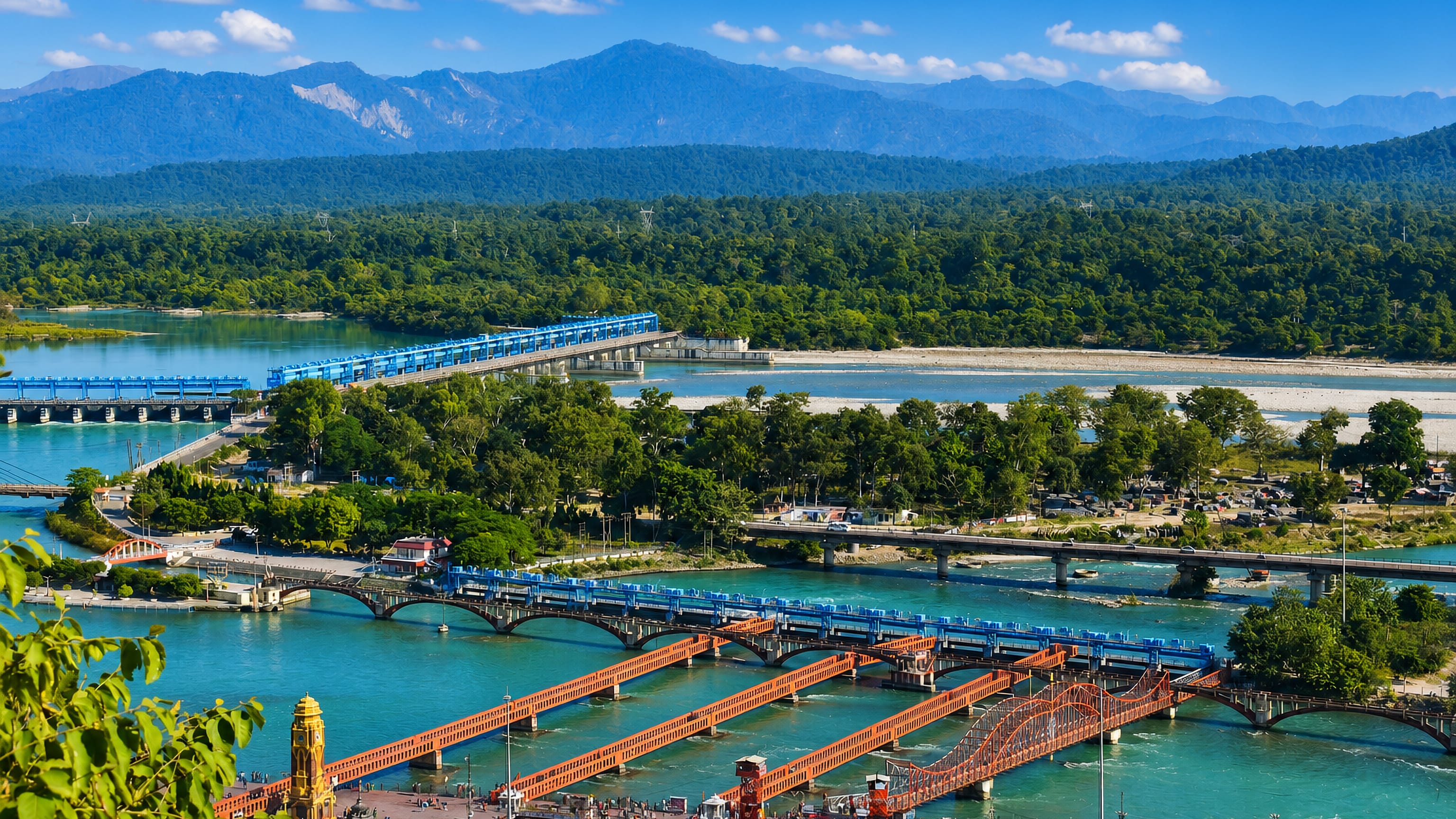 Bridges cross the turquoise Ganges past Haridwar's riverside ghats with Himalayan foothills beyond.