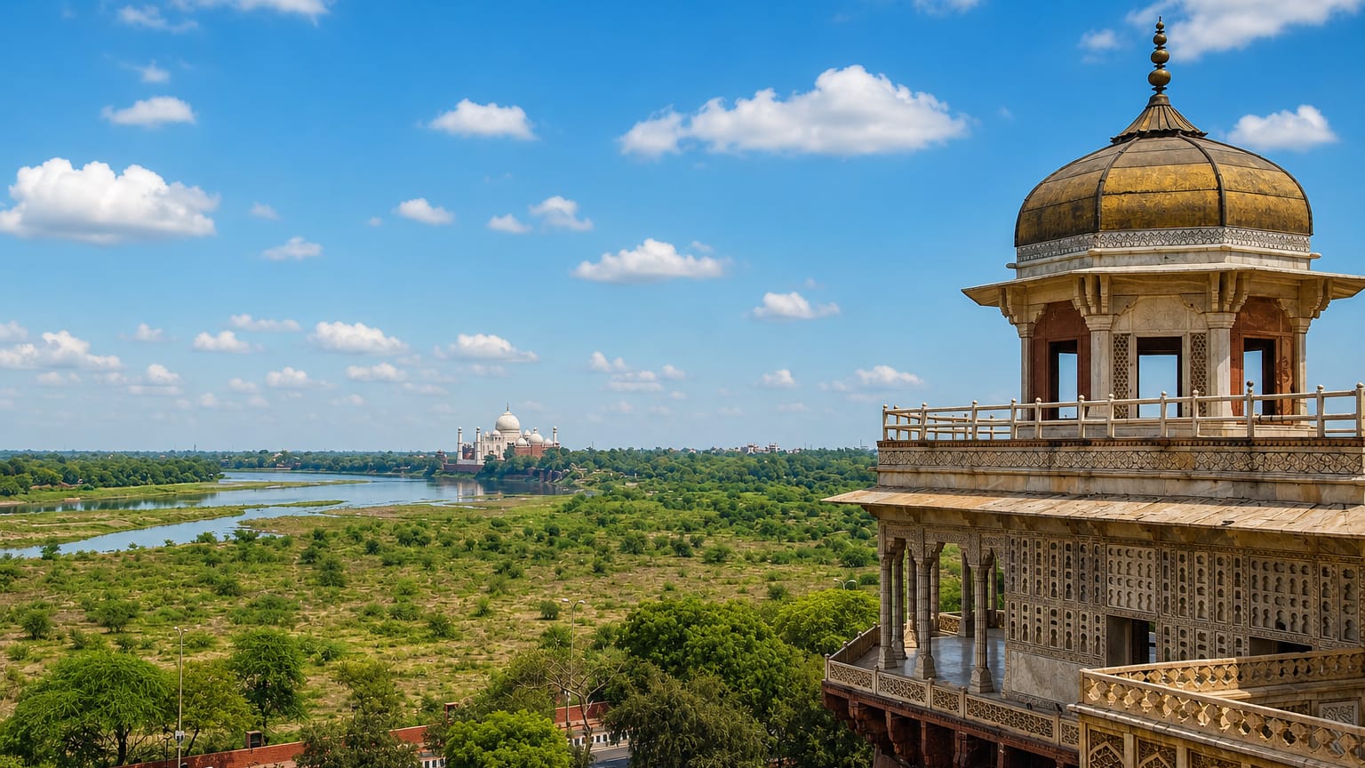 The Taj Mahal across the Yamuna river seen from an ornate Mughal marble pavilion at Agra Fort