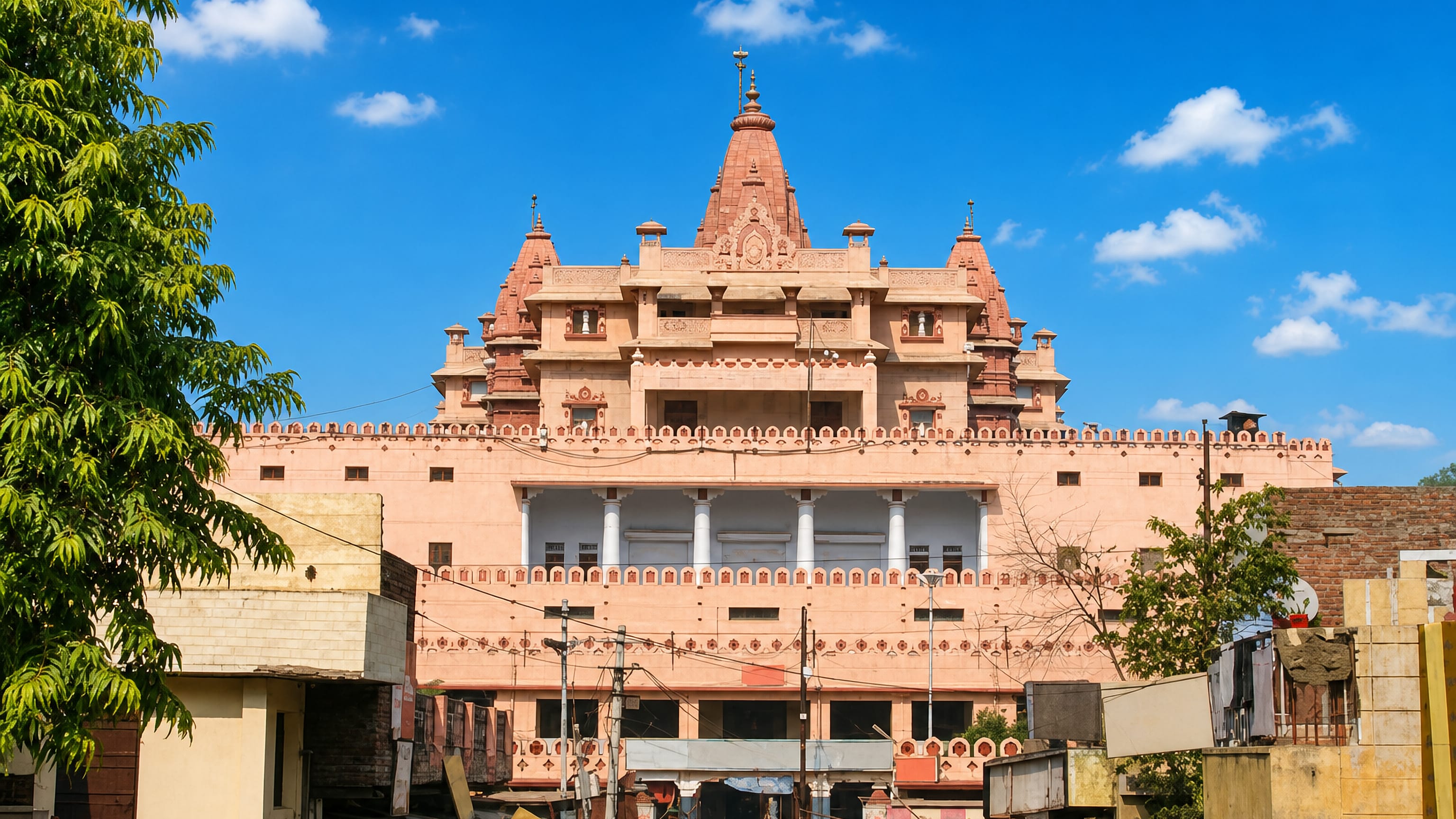 Shri Krishna Janmasthan temple complex in Mathura rising in salmon sandstone above the busy market lanes below.