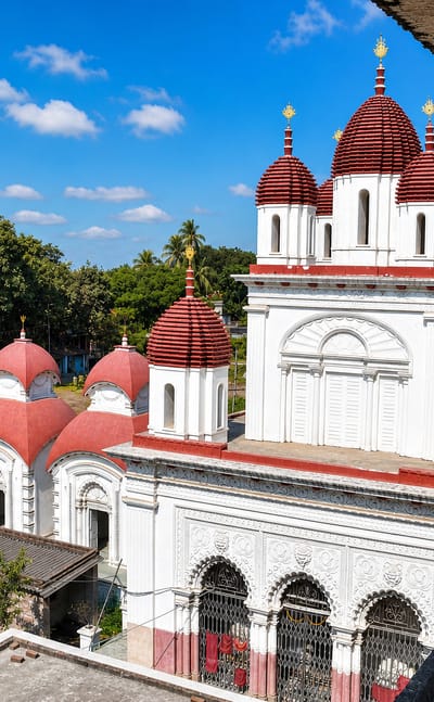 Red-domed Bengali temples with white terracotta facades in Baranagar, West Bengal.