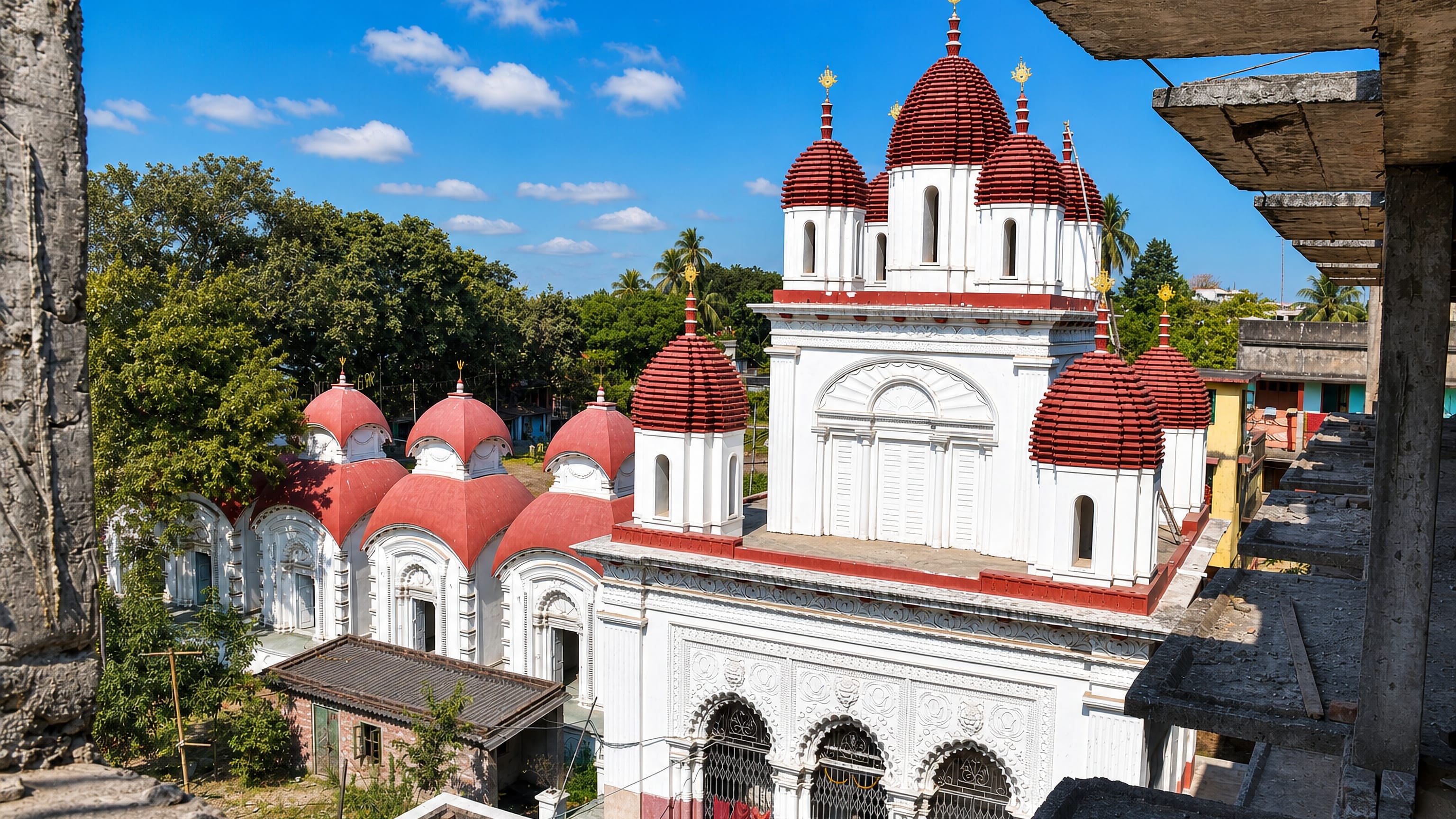 Red-domed Bengali temples with white terracotta facades in Baranagar, West Bengal.