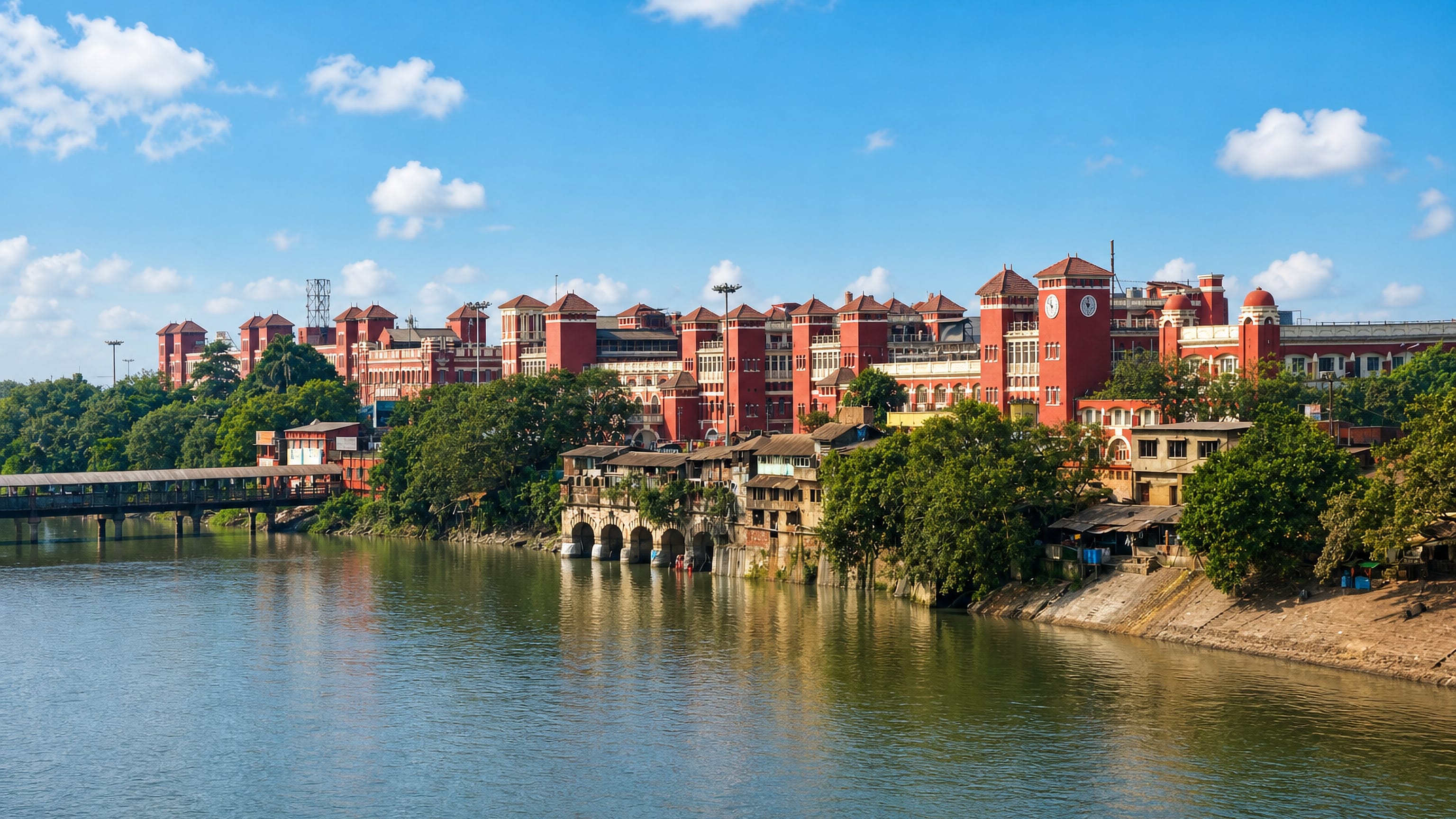The red-brick Howrah Station rising above the Hooghly riverbank in Howrah, West Bengal