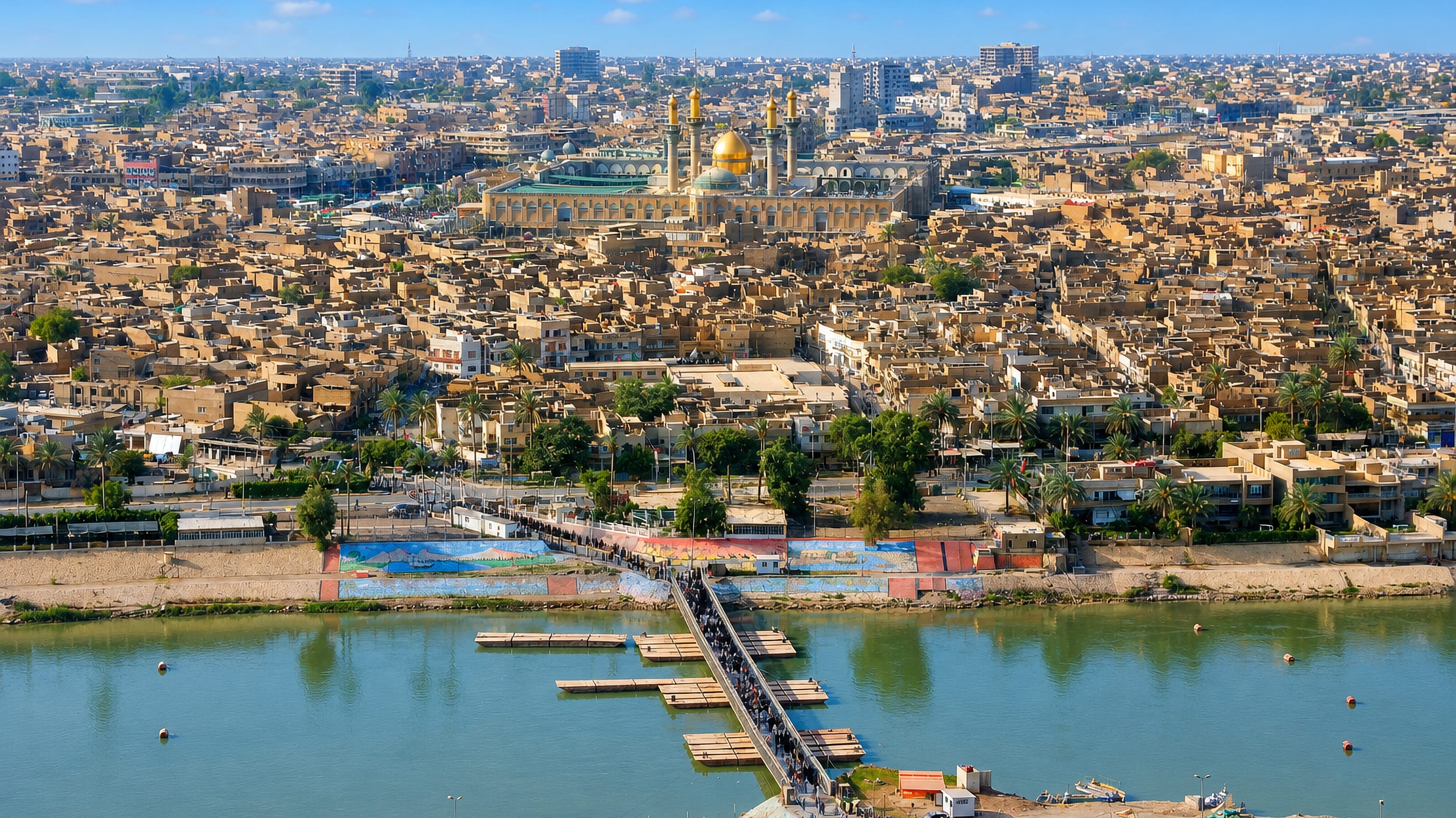 Golden domes and minarets of the Al-Kadhimiya Shrine rising over Baghdad's Kadhimiya district beside the Tigris