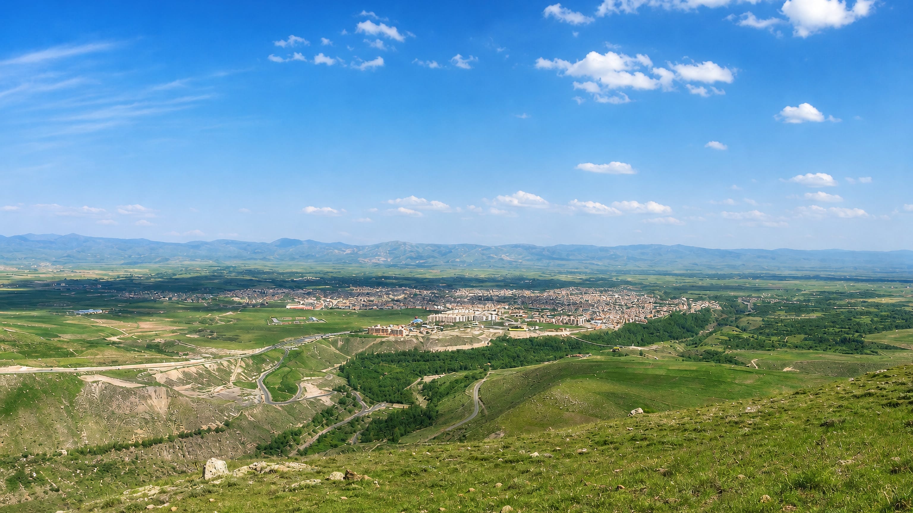 Meshgin Shahr, Iran, spread across a green upland plain below the mountain ranges of Ardabil Province