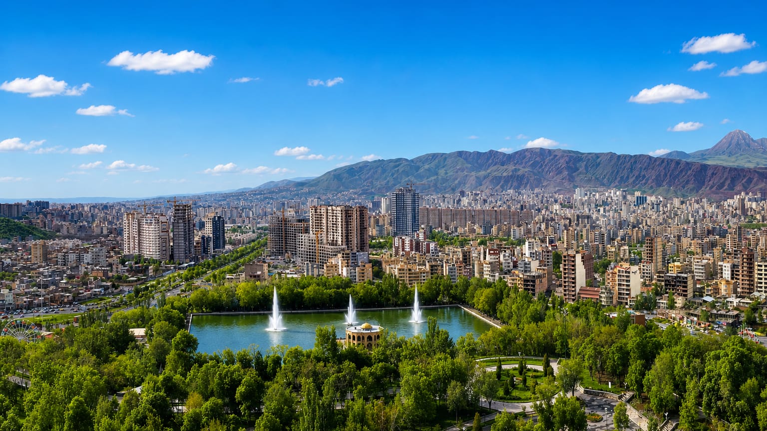 El Goli park lake and pavilion with fountains below the city and mountains, Tabriz, Iran