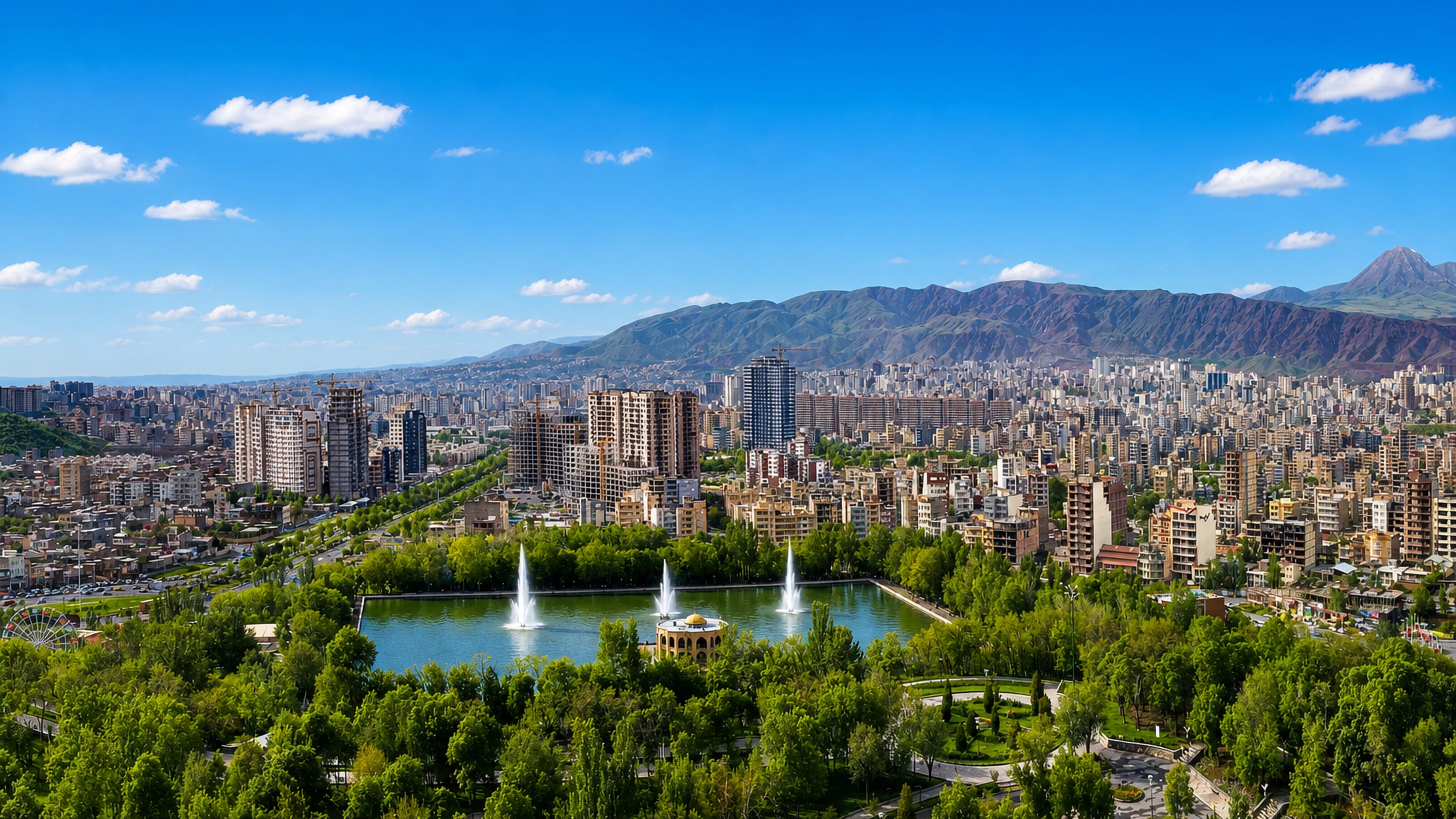 El Goli park lake and pavilion with fountains below the city and mountains, Tabriz, Iran