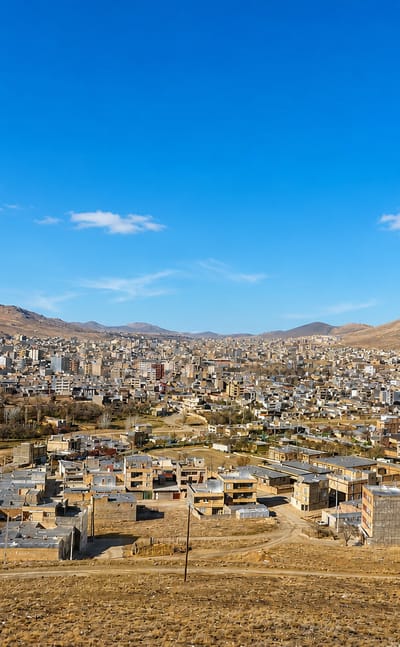 Bijar spreading across an arid valley in Kurdistan Province, ringed by bare brown mountains