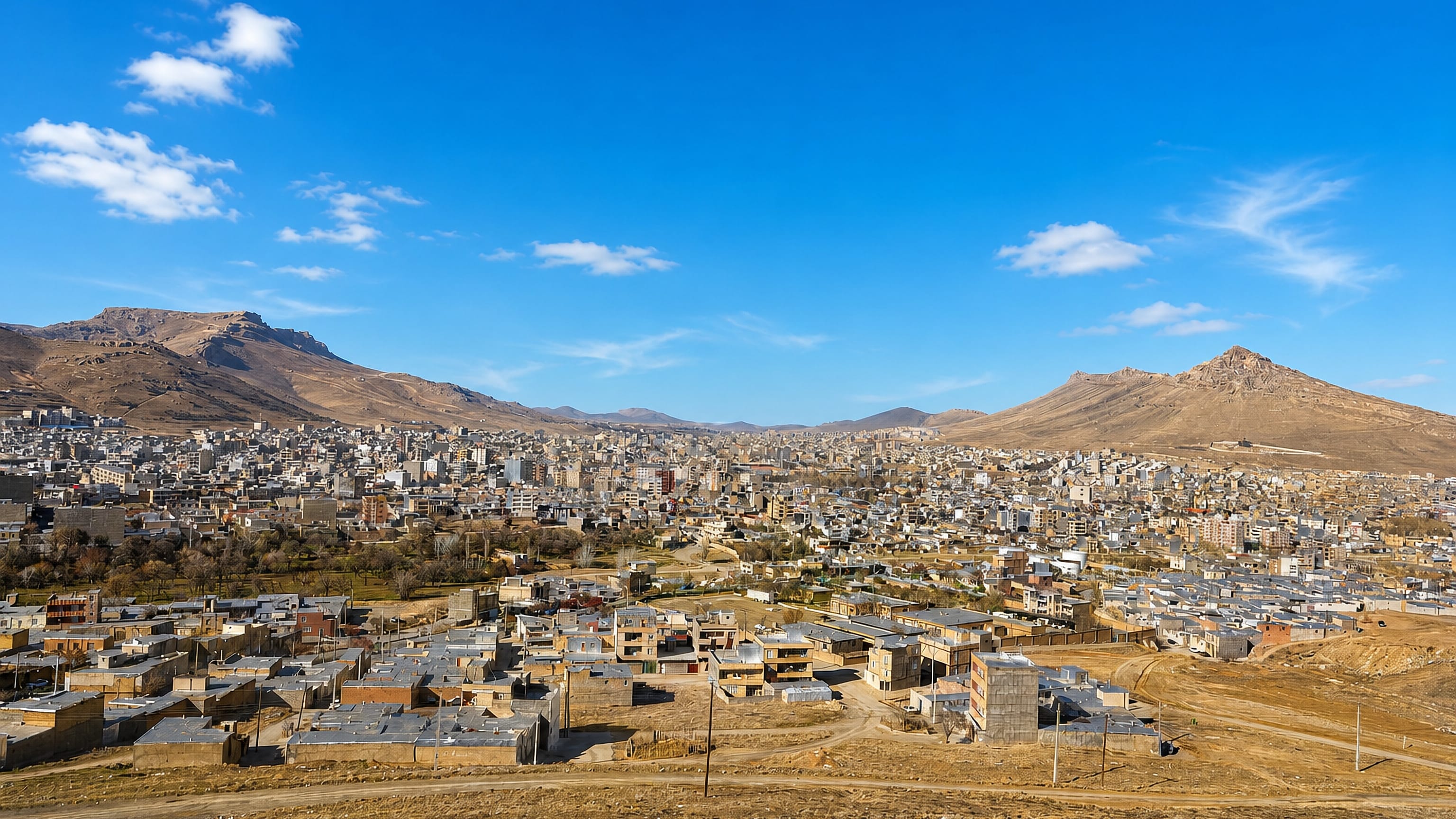 Bijar spreading across an arid valley in Kurdistan Province, ringed by bare brown mountains