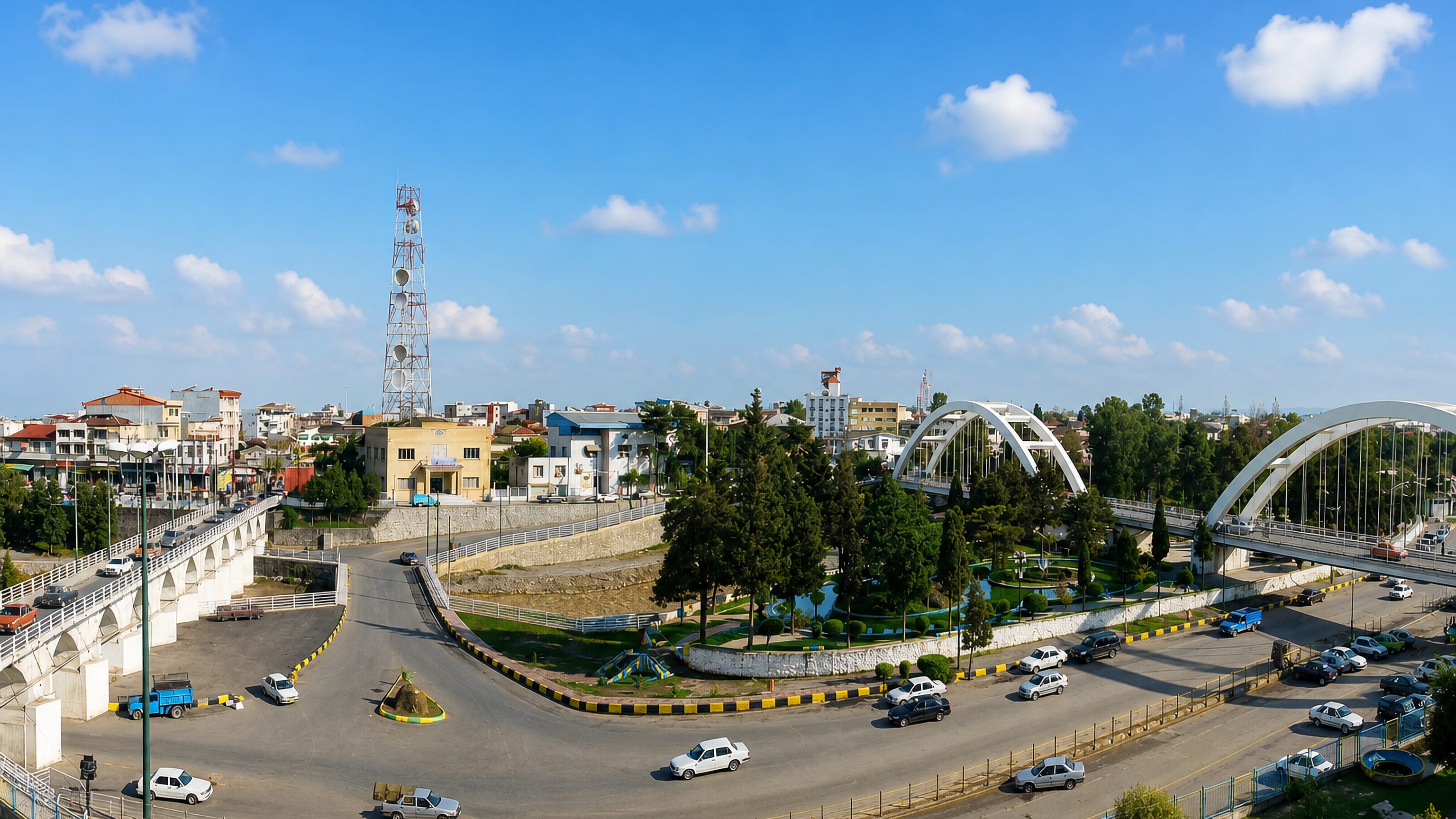 Amol, Iran: the historic twelve-arch stone bridge beside modern white arch bridges over the Haraz riverfront.