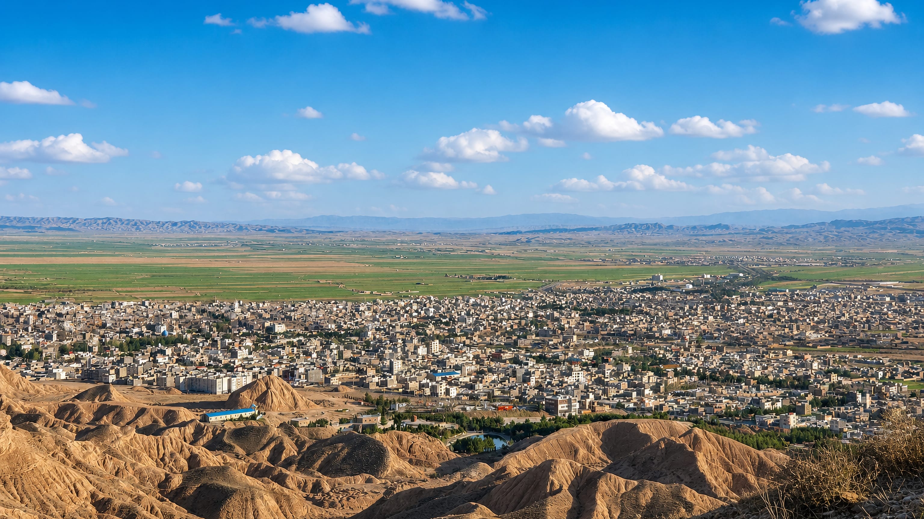Esfarayen spread across its plain in North Khorasan, seen from the eroded ochre hills that ring the Iranian town.