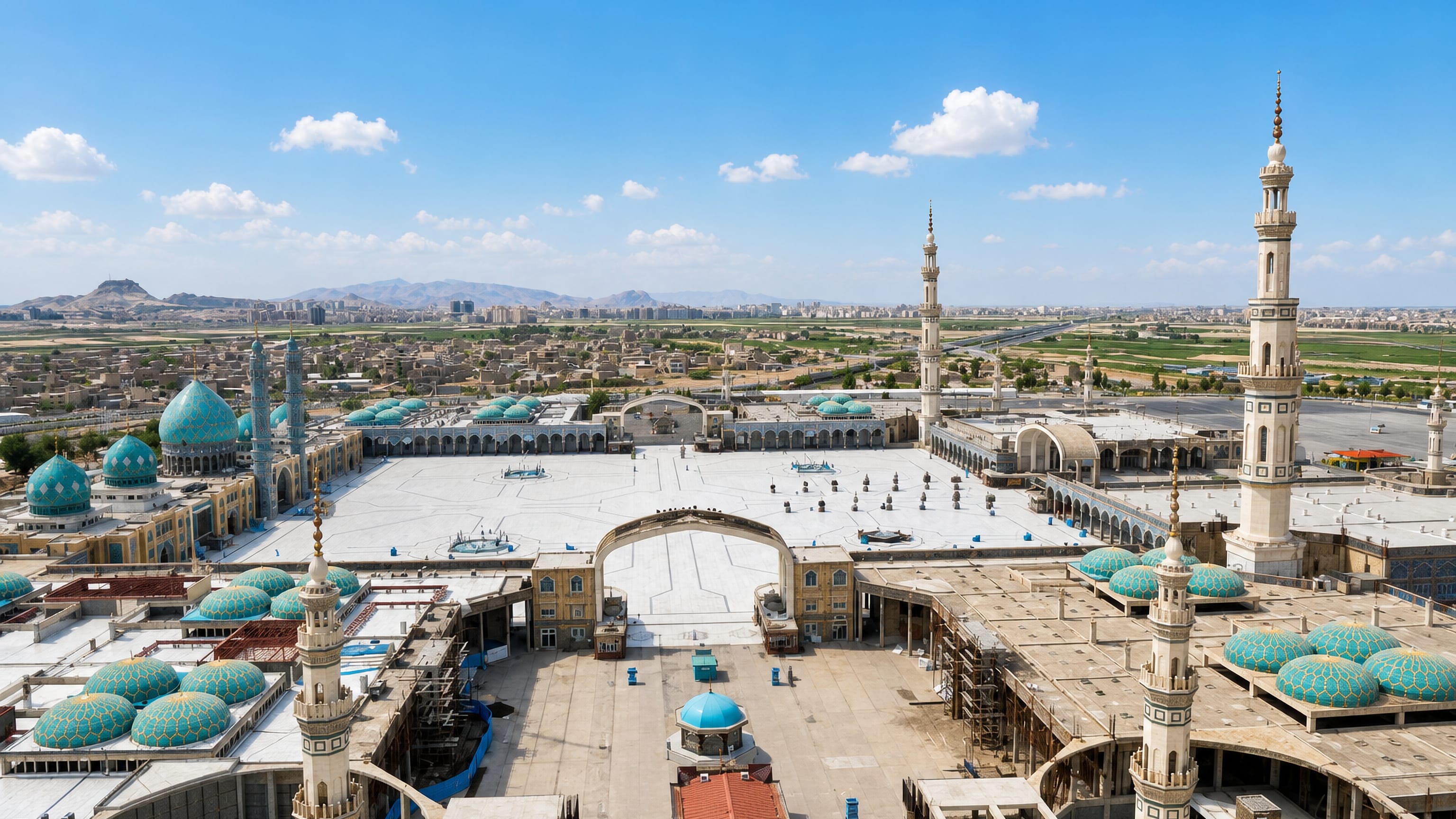 Turquoise domes and minarets of the Jamkaran Mosque with its vast courtyard on the plain outside Qom.