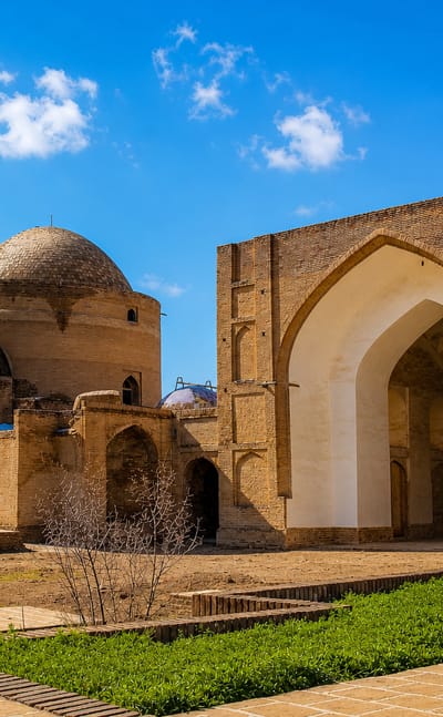 Brick iwans and the domed shrine of the historic mausoleum complex in Torbat-e Heydariyeh, Iran.