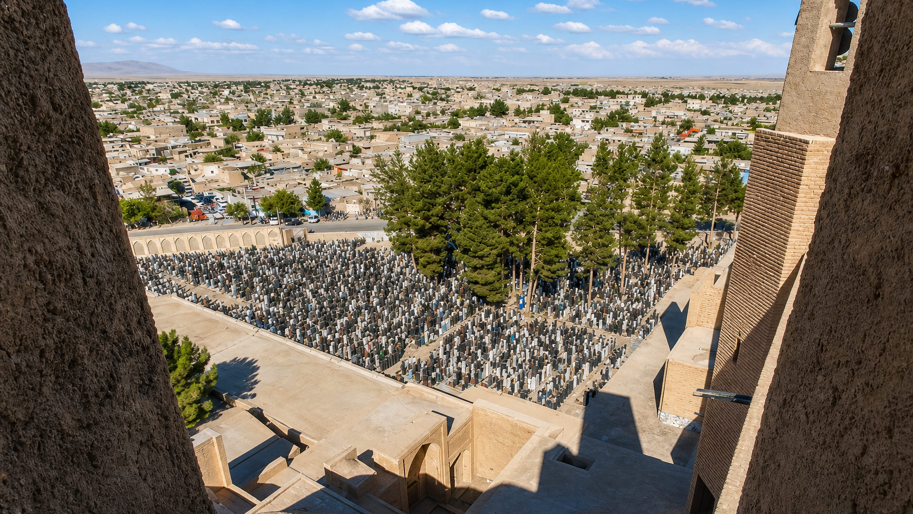 View from the brick shrine complex over the cemetery and low desert town of Torbat-e Jam, Iran.