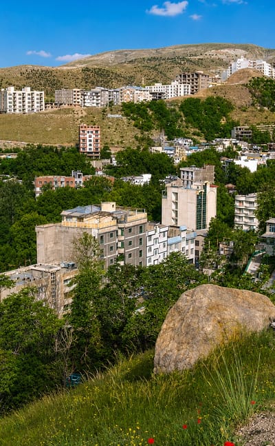 Hillside residential buildings of Evin at the Alborz foothills in northern Tehran, dry slopes behind