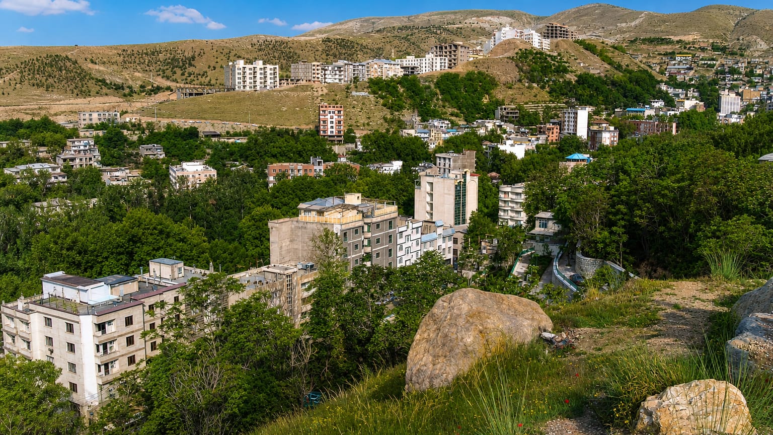 Hillside residential buildings of Evin at the Alborz foothills in northern Tehran, dry slopes behind