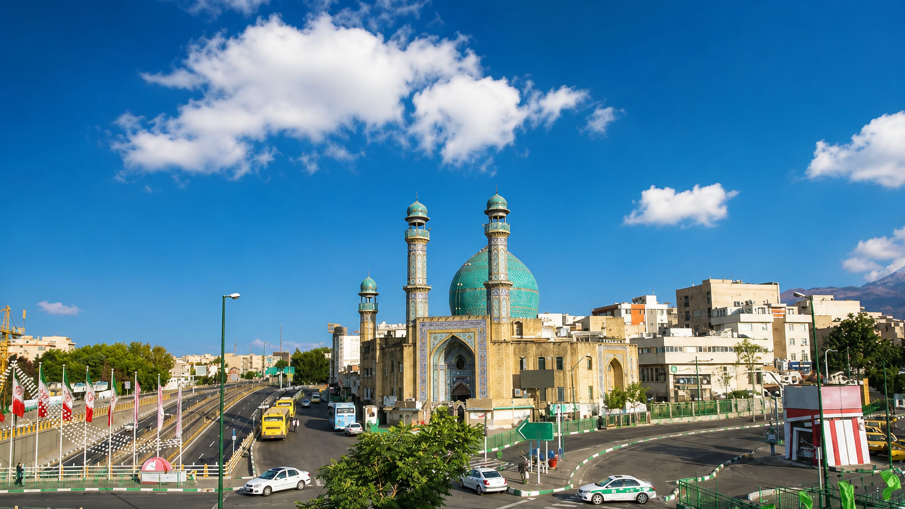Turquoise-domed mosque and minarets beside a busy highway junction in Narmak, eastern Tehran
