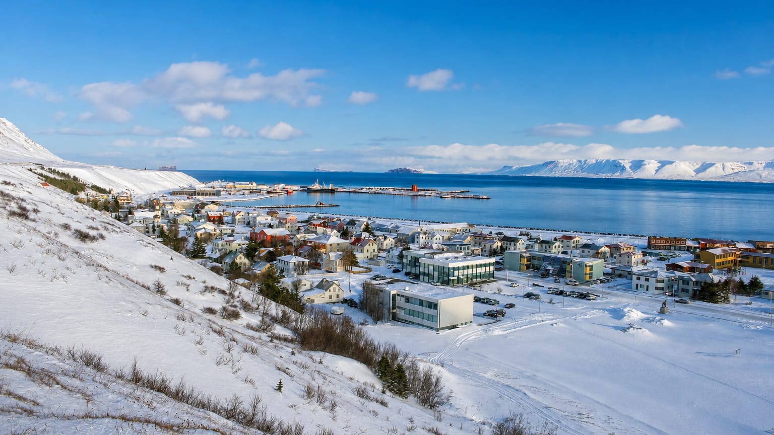 Elevated winter view over Sauðárkrókur, Iceland, with its harbour and the Skagafjörður fjord beneath snowy hills.