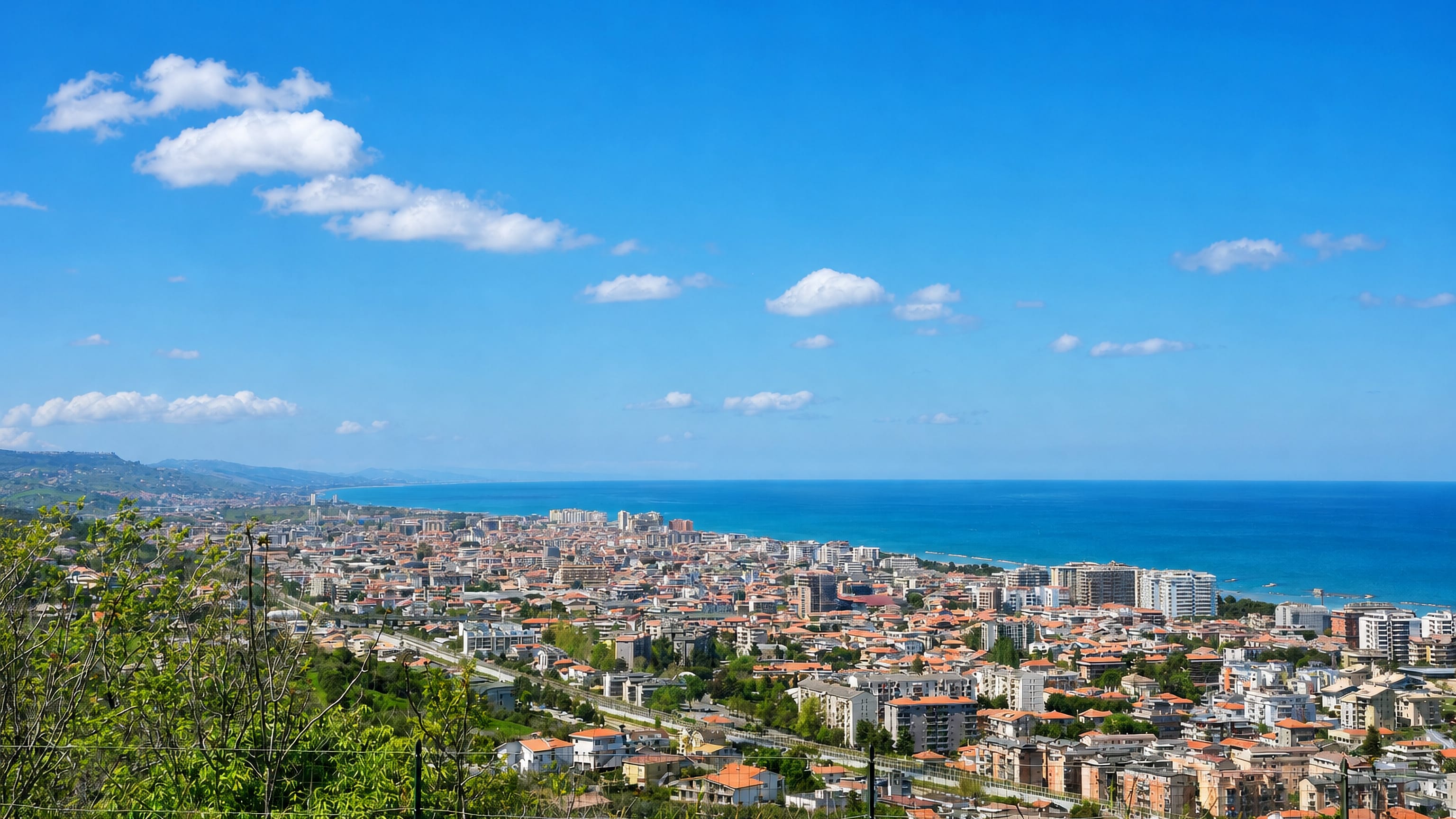 Panorama from the hills over Montesilvano, Italy, its terracotta roofs and Adriatic beachfront.