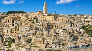 Matera's Sassi districts of stacked stone cave dwellings rising to the cathedral campanile