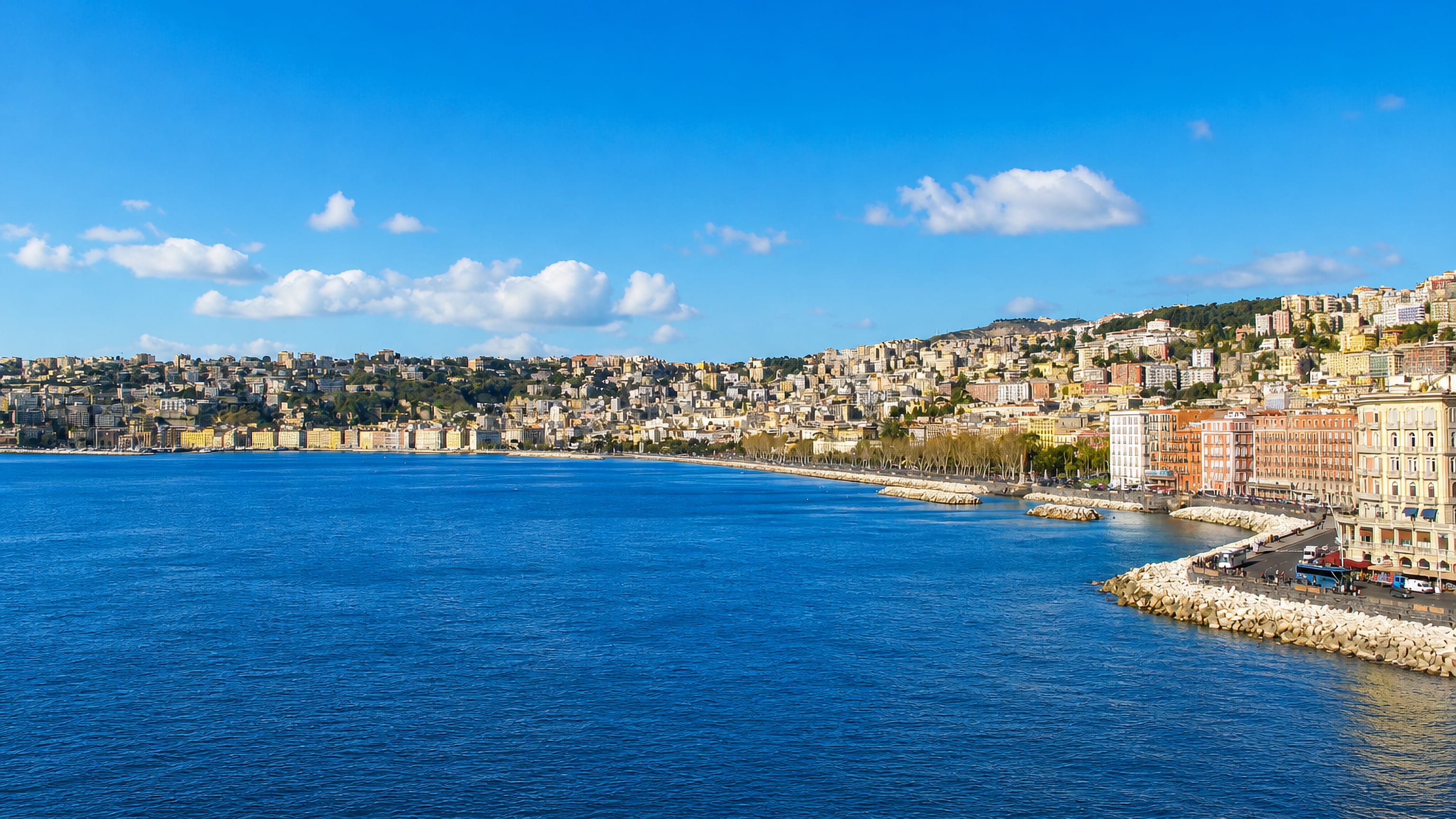 Curving seafront palazzi and breakwater along the Bay of Naples in San Ferdinando.