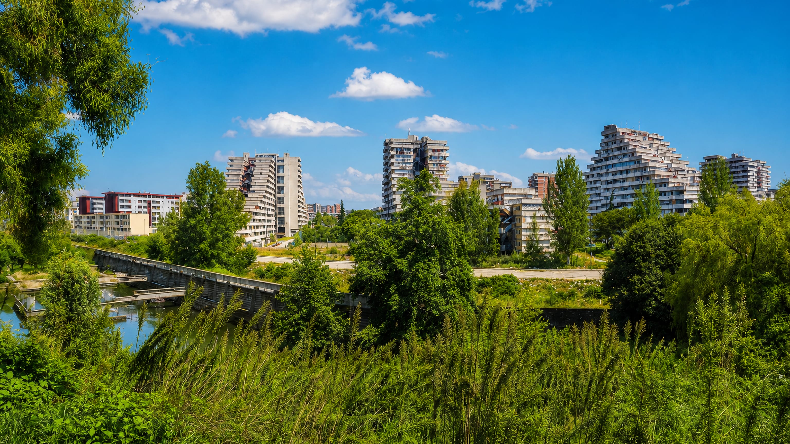 Stepped modernist housing blocks above overgrown ground in Scampia, on the northern edge of Naples.