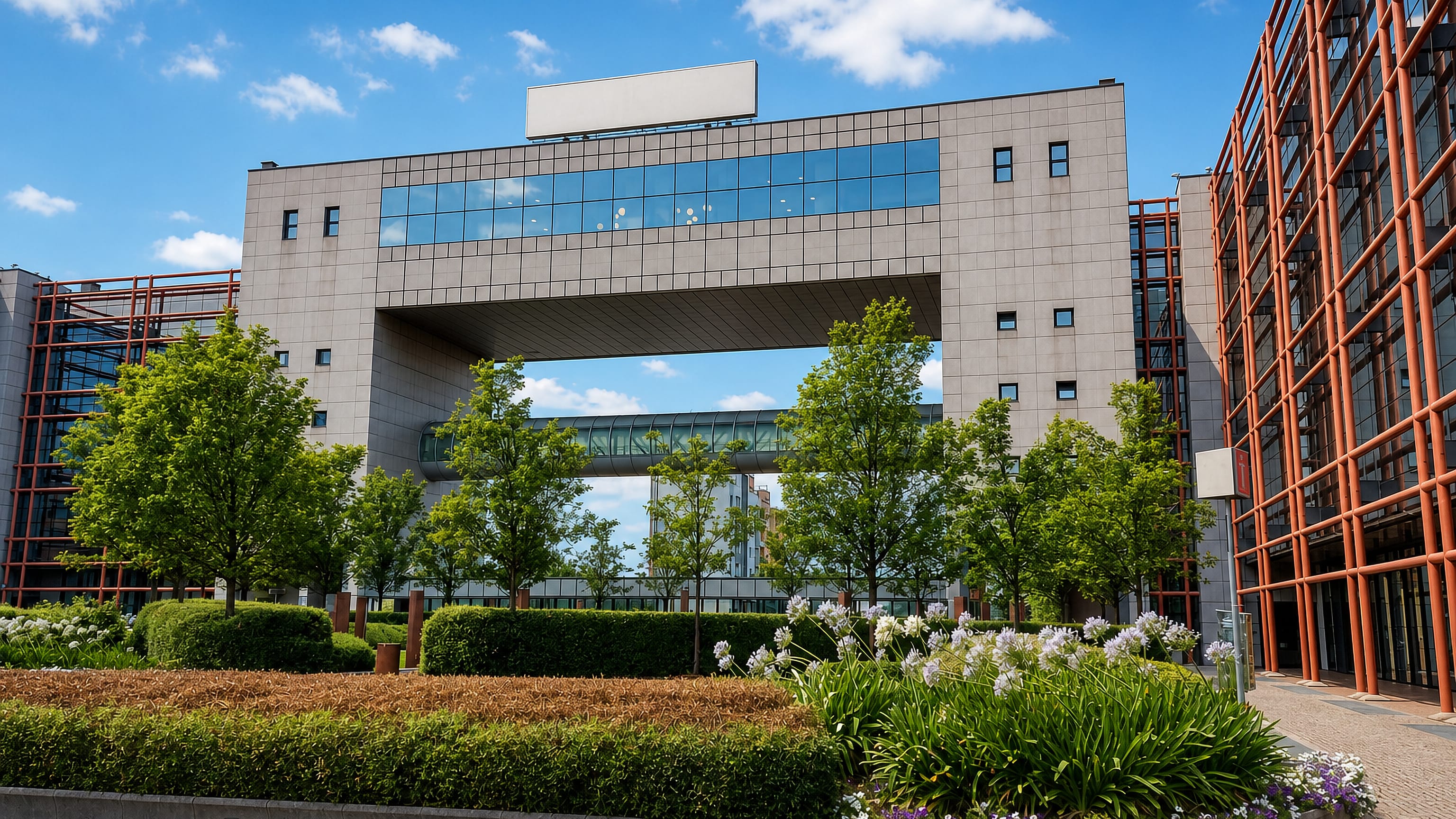 Modern steel-and-glass office complex with a gateway bridge in Bologna's San Donato - San Vitale district.