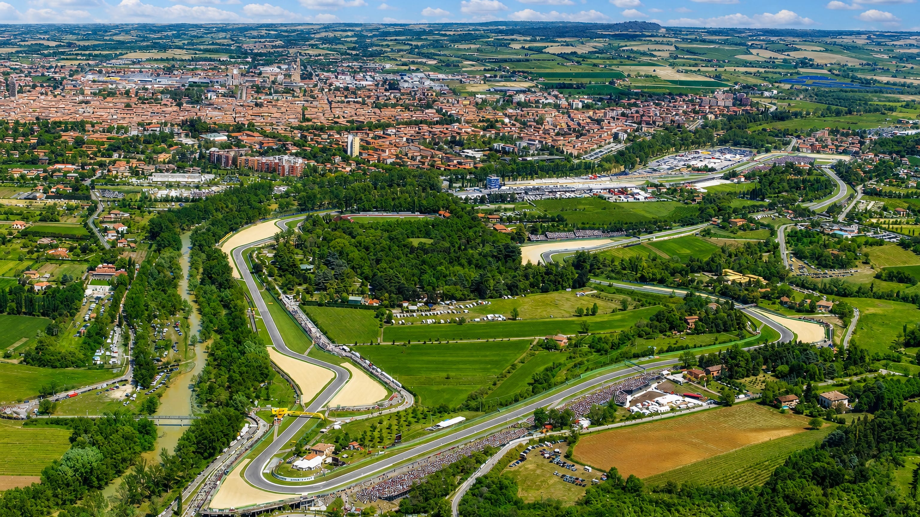 Aerial view of Imola with the Autodromo circuit winding beside the Santerno river and the old town beyond.