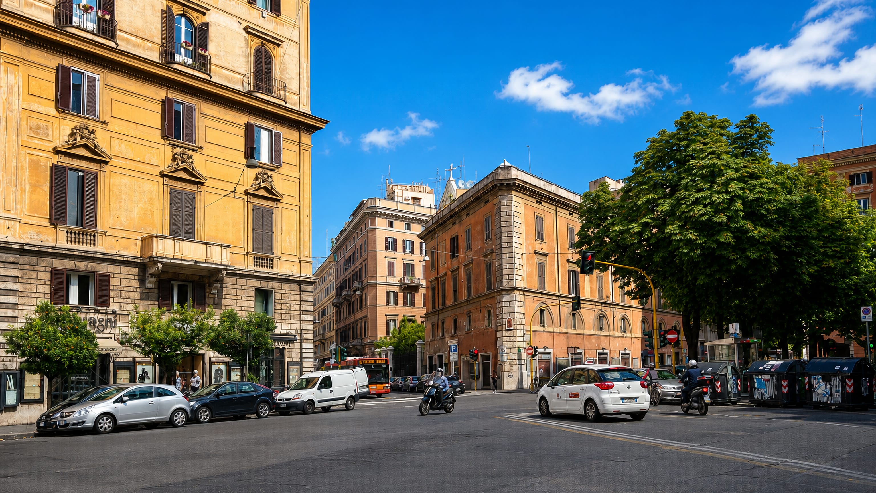 Sunlit street corner in Rome with ochre palazzi, parked cars and a clear blue sky in the Castro Pretorio quarter
